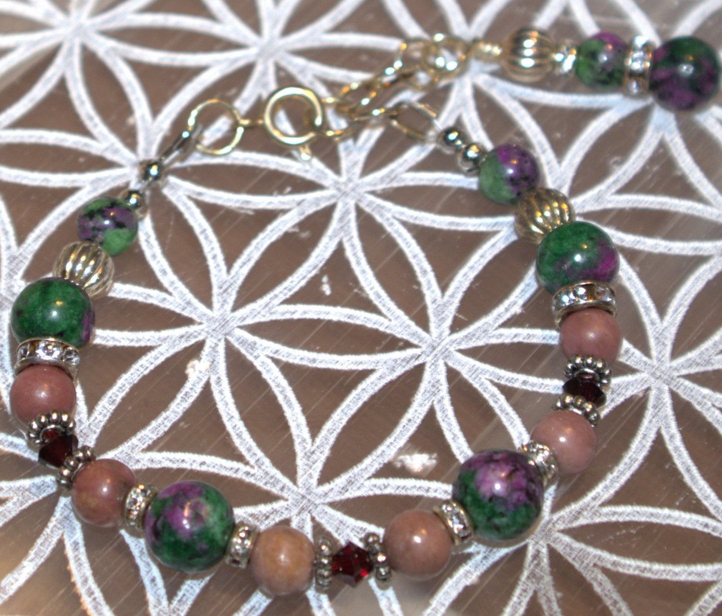 Multicolored beaded bracelet on a white and gray patterned surface