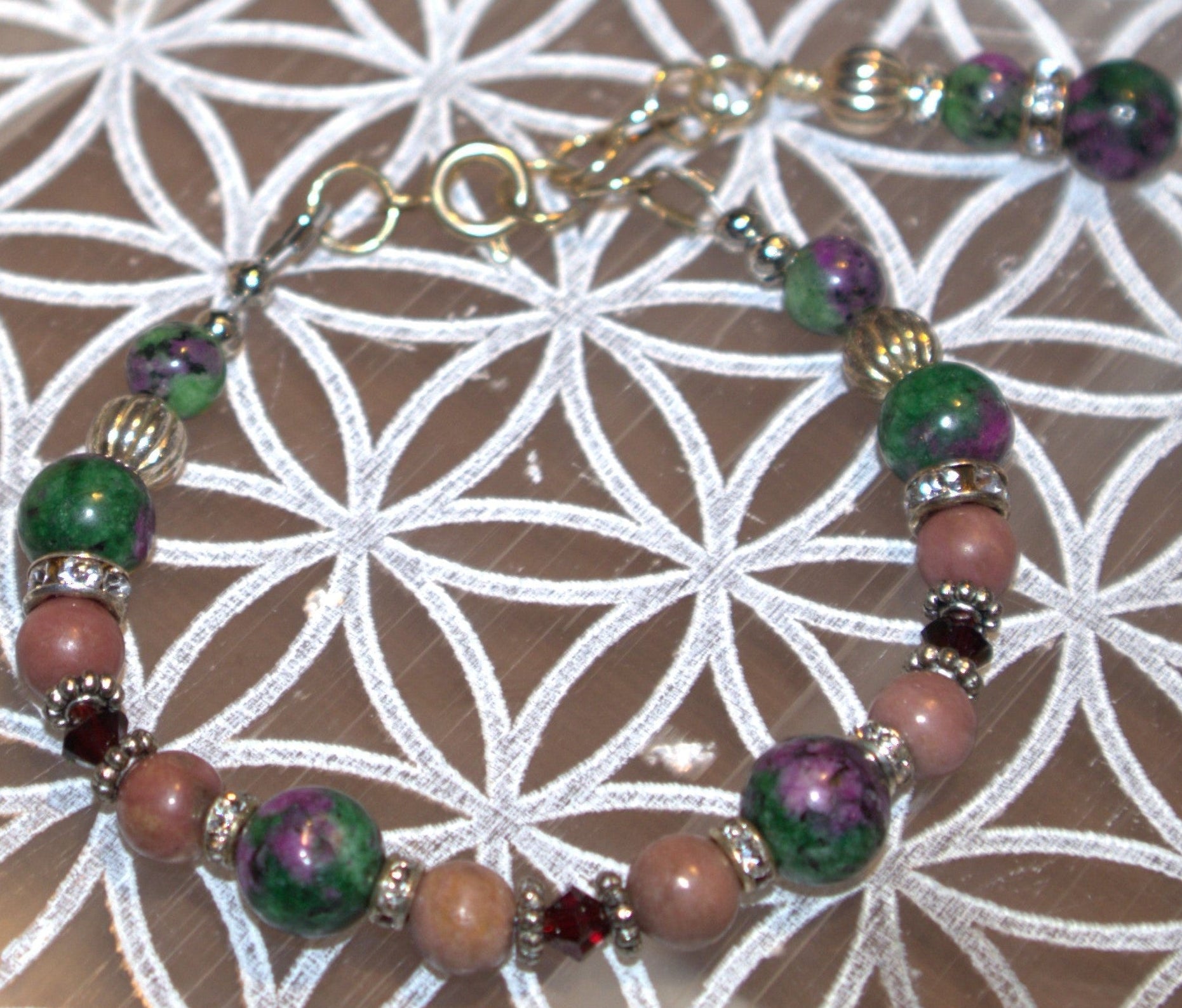 Multicolored beaded bracelet on a white and gray patterned surface